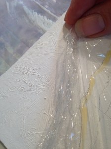 Adding plastic wrap into wet gesso creates a water-like texture